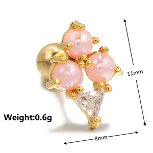Macro detail of heart-shaped zircon ear stud with opal gems and golden screw back