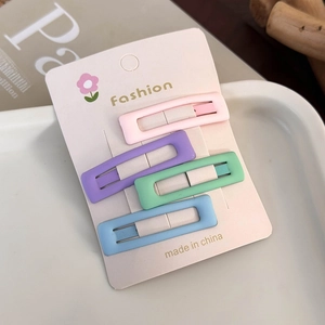 Set of four colorful rectangular hair clips in pastel pink, purple, green, and blue