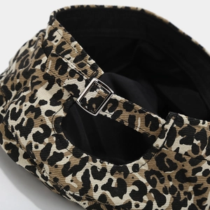 Detailed close-up of leopard print beret with adjustable silver metal buckle and fabric texture