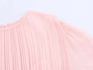 Detail of elegant round neckline and pleated chiffon fabric texture on pink dress