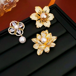Three elegant gold-plated flower brooches with micro-pave zircons and white pearls