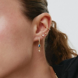 Chic gold drop earrings with blue marquise stone and sparkling zircon stud set on ear