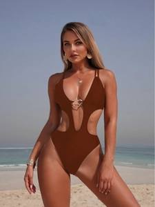 Deep brown cutout one-piece swimsuit with heart-shaped metal buckle on beach