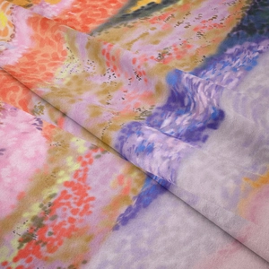 Close-up of soft colorful abstract print fabric with smooth texture and silk-like drape