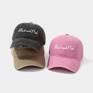 Macro detail of high-quality Black and Pink embroidery on washed vintage cotton caps