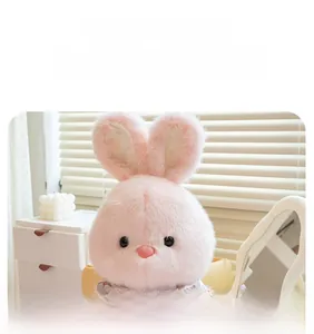 Detail of pink plush rabbit toy with soft fluffy texture and a decorative scarf