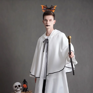 Detail of Halloween costume showing white cape with black trim and bat wing headband