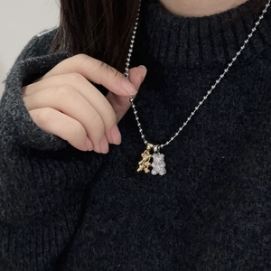 Close-up of double bear pendants with micro-pave zircons on a round bead chain necklace