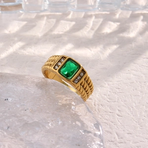 Macro view of 18K gold plated ring featuring a square green zircon and textured band