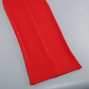 Detail of red off-shoulder dress showing smooth fabric texture and fine stitching craft
