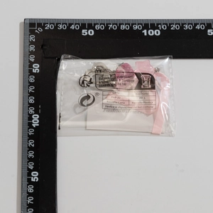 Detail view of pink flower bow keychain with measuring ruler showing 5cm product size