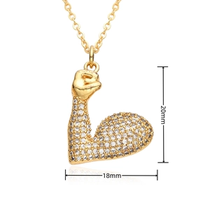 Detail view of hip hop gold fist pendant with dimensions 20mm by 18mm and clear crystals