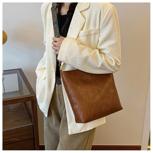 Detail of vintage brown tote bag featuring unique ethnic woven wide shoulder strap