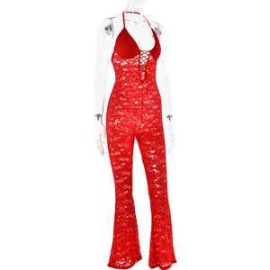 Detail of red lace halter jumpsuit featuring a lace-up neckline and flared leg design