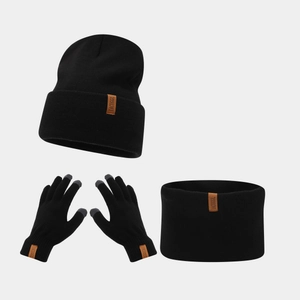 Detailed view of black knitted beanie, scarf and touchscreen gloves with leather patch