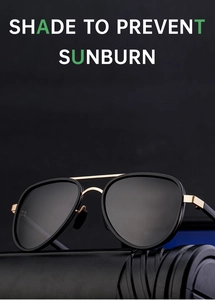 Detail of pilot sunglasses with black frame and gold bridge on a black stand