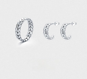 Detailed macro shot of vintage 925 sterling silver leaf ring and earrings set with zircons