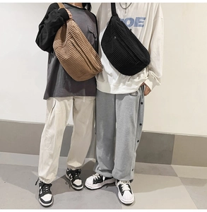 Close-up of brown and black corduroy crossbody bags showing texture and fit on models