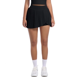 Detail of high-waist black pleated skort featuring asymmetric hem and built-in liner shorts