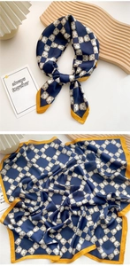 Detail of silk square scarf featuring navy blue horsebit pattern and ginger yellow edges
