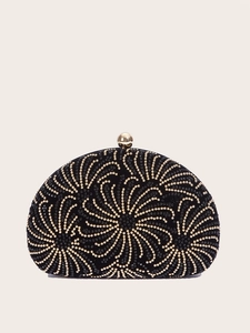 Detail of shell evening bag with black velvet, gold beadwork, and floral swirl patterns
