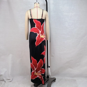 Detail of red floral print maxi dress featuring adjustable thin black straps on mannequin