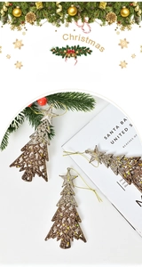 Close-up of glittery gold and bronze hollow Christmas tree ornaments with star topper
