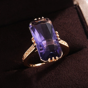 Vintage gold cocktail ring with rectangle purple gemstone and carved openwork band