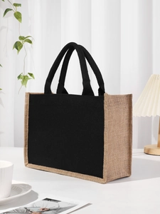Detail of eco-friendly linen canvas tote bag with black handles in a lifestyle setting