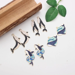 Enamel whale charm set in gold plating with blue and white wave designs for DIY jewelry