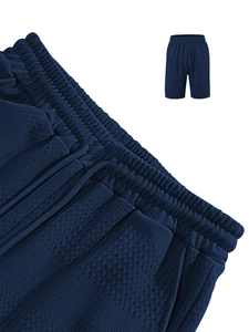 Close-up of navy blue waffle knit fabric texture on men casual drawstring beach shorts