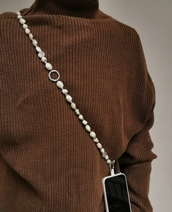 Detail of bohemian irregular shell beads crossbody phone strap with silver metal clasp
