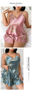 Detailed view of floral satin sleepwear set with V-neck camisole and ruffled hem shorts