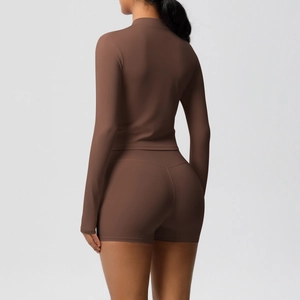 Back view of dark brown yoga set featuring a long sleeve tight top and high waist shorts