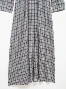 Close-up of blue and brown plaid dress showing crinkled seersucker fabric texture