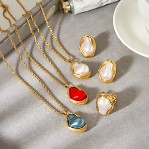 Baroque pearl necklaces set with gold twist chains and colorful teardrop pendants