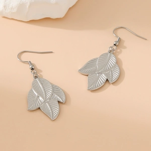 Elegant silver leaf-shaped stainless steel drop earrings shown on a minimalist background