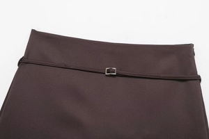 Detail of dark brown twill skirt waist with matching thin belt and silver buckle