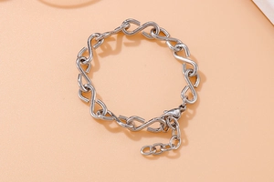 Macro detail of silver infinity link bracelet with adjustable lobster clasp closure