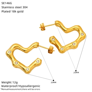Detail view of 18k gold plated textured heart earrings with 25mm size specifications