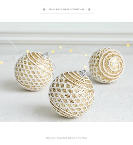 Detail of elegant gold and white Christmas balls with lace texture and glitter finish