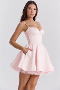 Detail of pink satin mini dress showing corset bodice and pleated puff hem with mesh lining