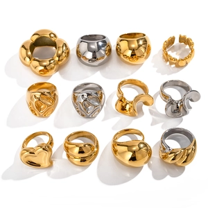 Collection of oversized 18K gold and silver stainless steel rings with organic shapes