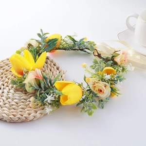 Close-up of floral wreath hairpiece with yellow tulips and pink-orange roses