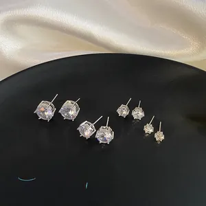 Macro view of four sizes of silver stud earrings with sparkling round cubic zirconia