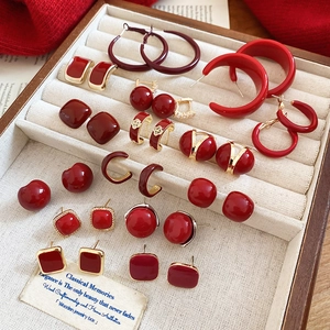 Close-up of red geometric earrings in a velvet jewelry box with vintage aesthetics