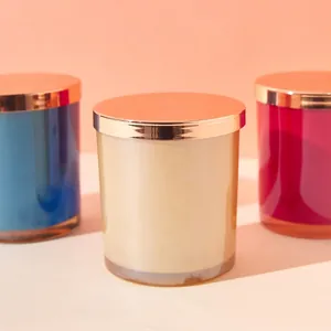 Luxury electroplated glass candle jars in gold, blue, and rose red with metallic lids