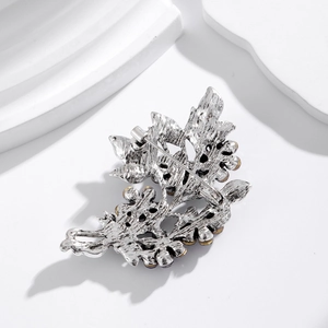 Elegant crystal leaf brooch with silver hollow metal back and secure safety pin closure