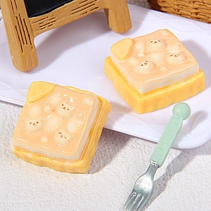 Miniature resin cat toast charms on a white plate for DIY crafts and decor