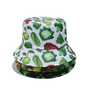 Stacked bucket hats with colorful vegetable prints featuring broccoli on white background